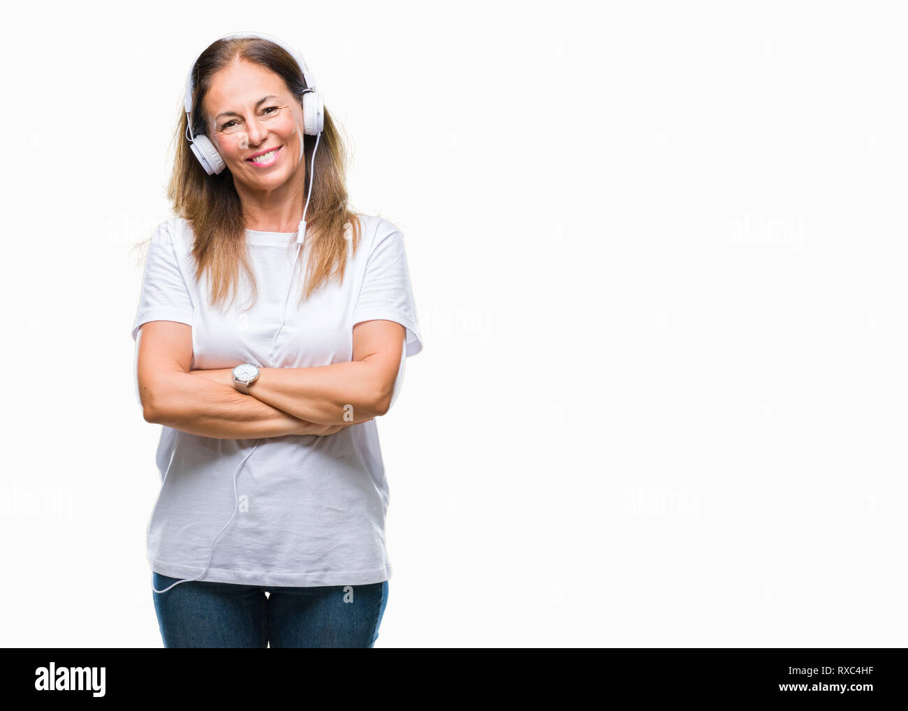Middle age hispanic woman listening to music wearing headphones over ...