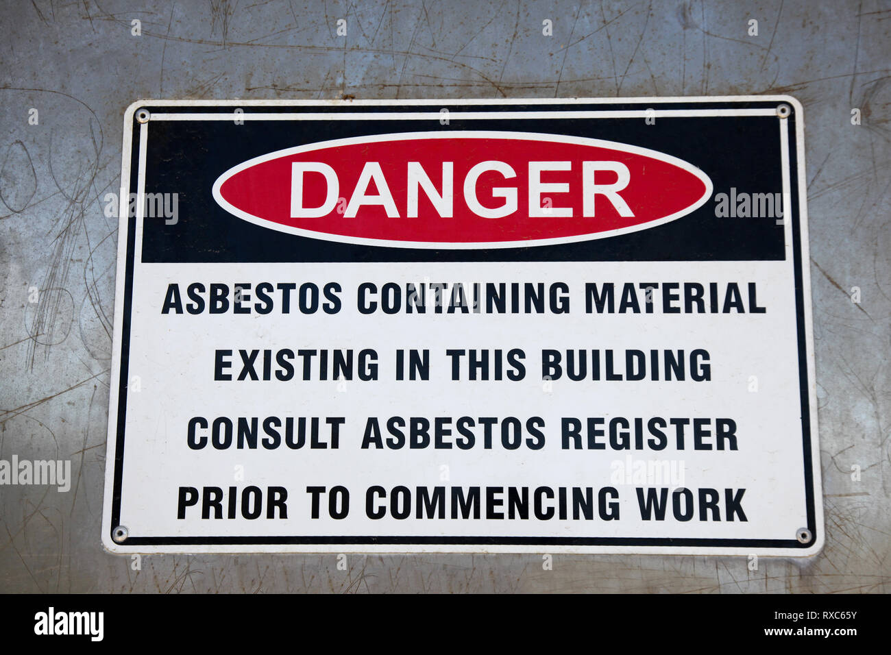 An Asbestos Warning Sign highlighting the dangers of Asbestos containing materials. Stock Photo