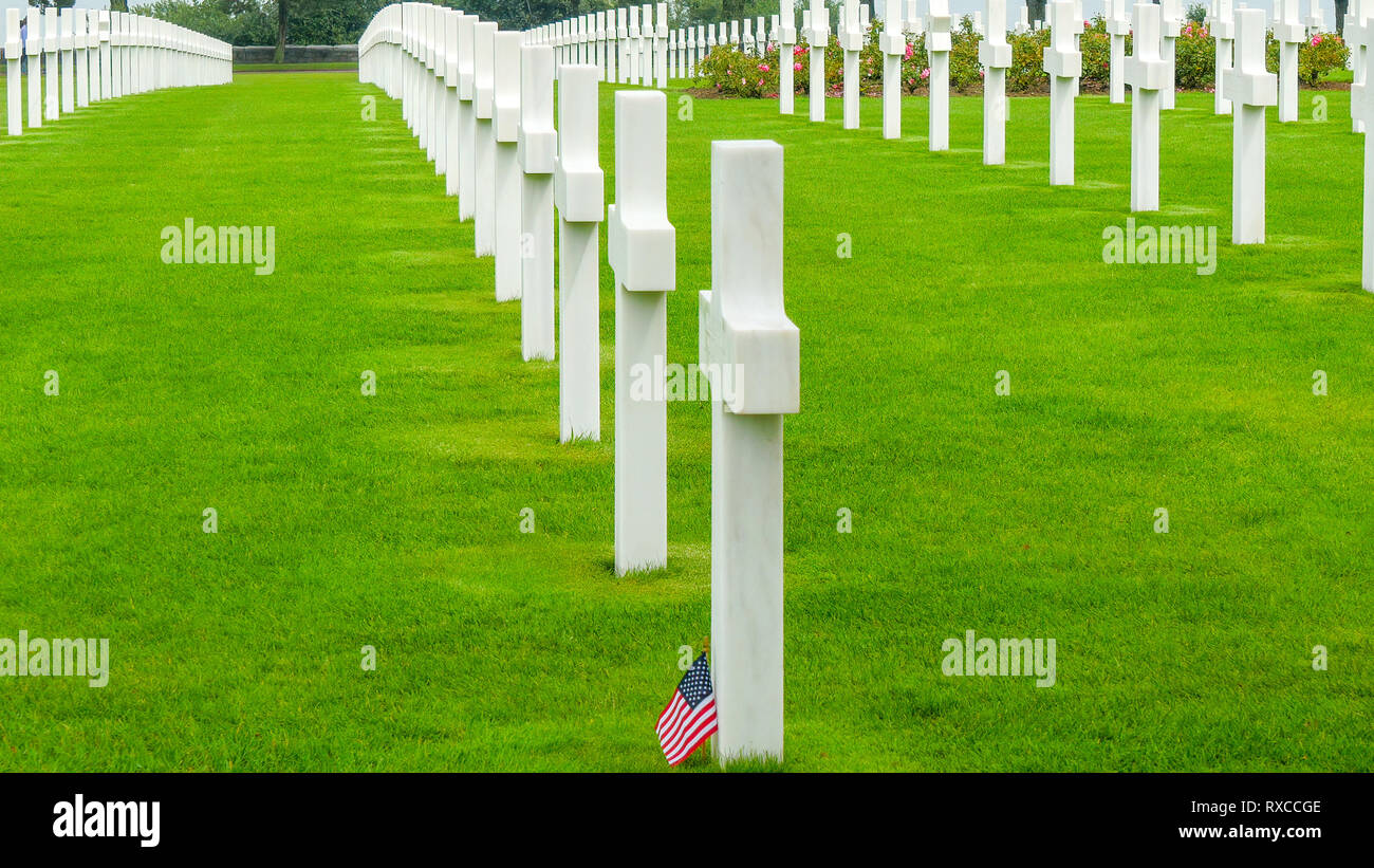 One of the cross in the cemetery with an American flaglet found on the bottom of the tomb Stock Photo