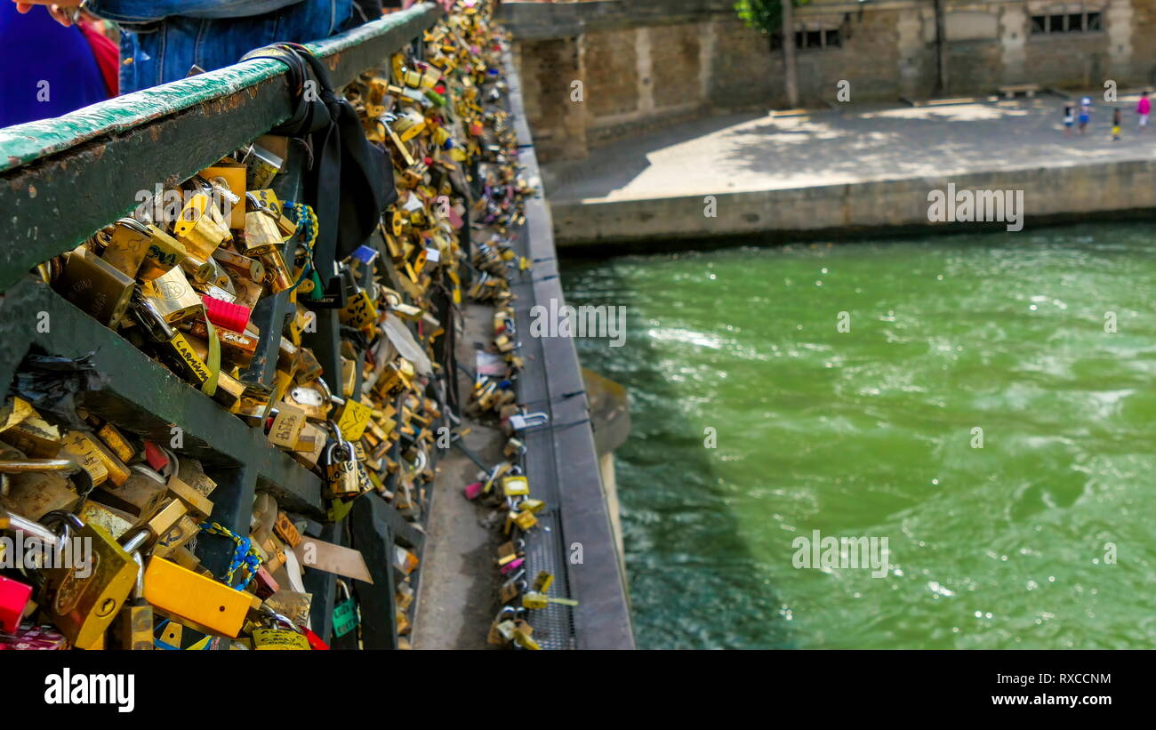 Different kinds of padlocks locked on the bridge. This famous love lock