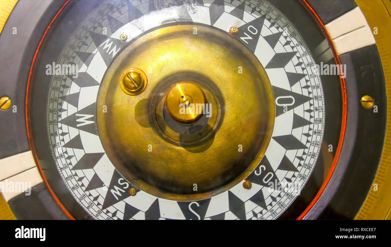 A huge compass inside the captains deck. A compass is an instrument