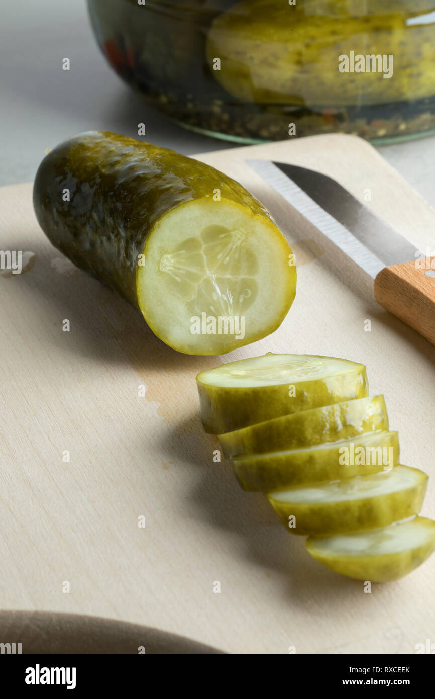 Sliced pickled gherkin close up on a cutting board Stock Photo