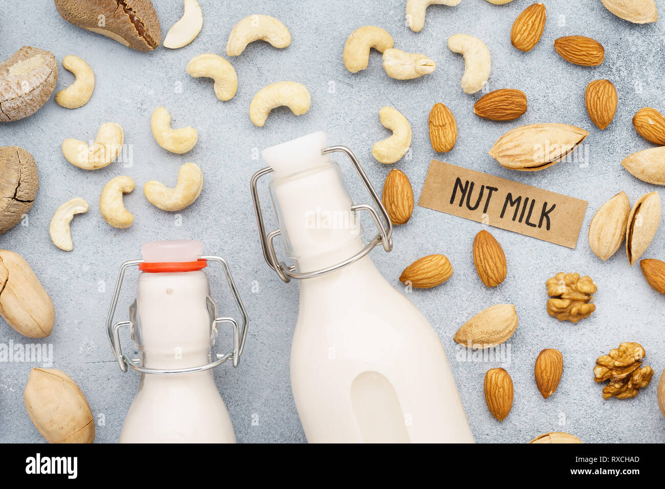 Vegan nut milk and various nuts. Ingredients for milk substitute. Top