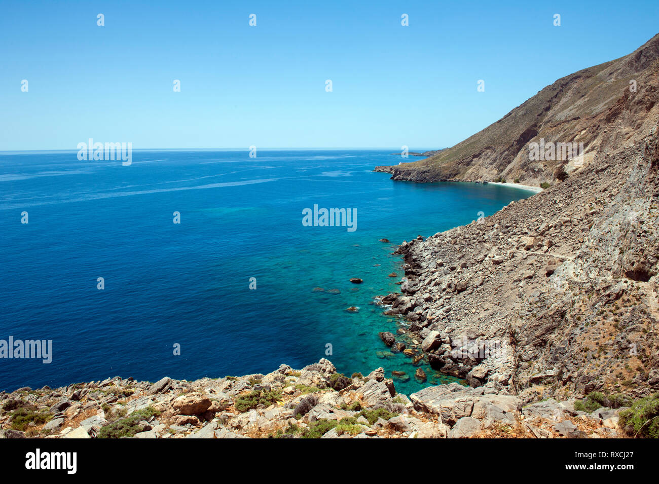 View of the southern coast of Crete between the villages of Hora Sfakion and Loutro with secluded Sweetwater Beach in the distance. Stock Photo