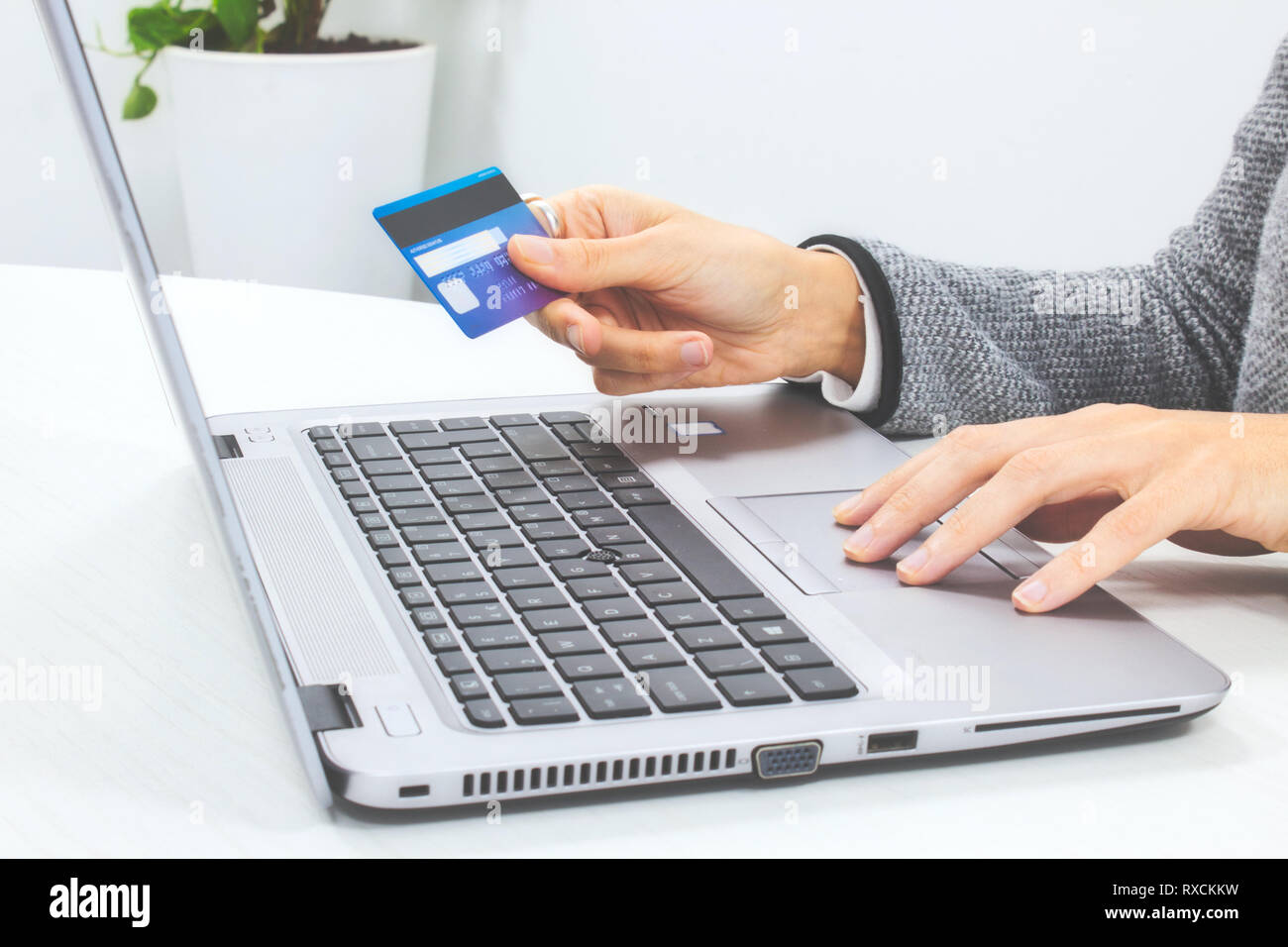 Woman making an online payment with her credit card and laptop computer Stock Photo