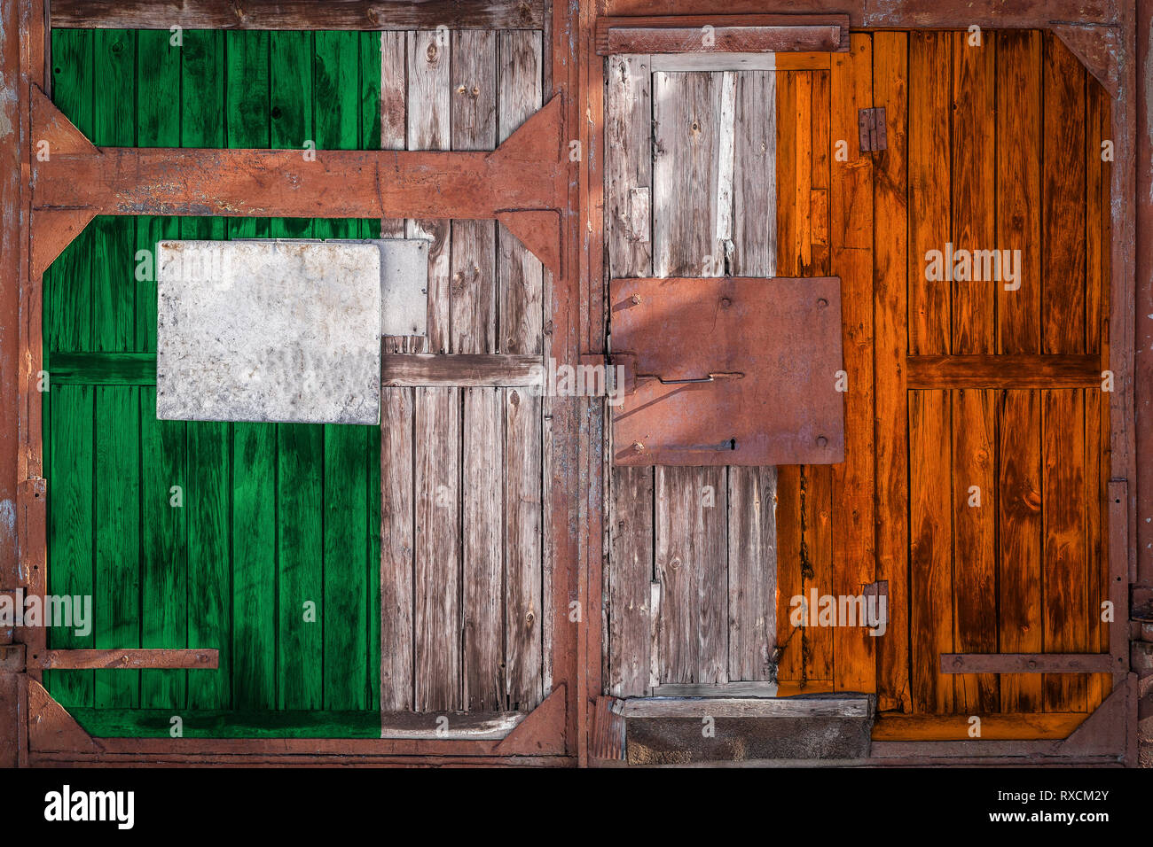 Closeup of old warehouse gate with national flag of ireland. The