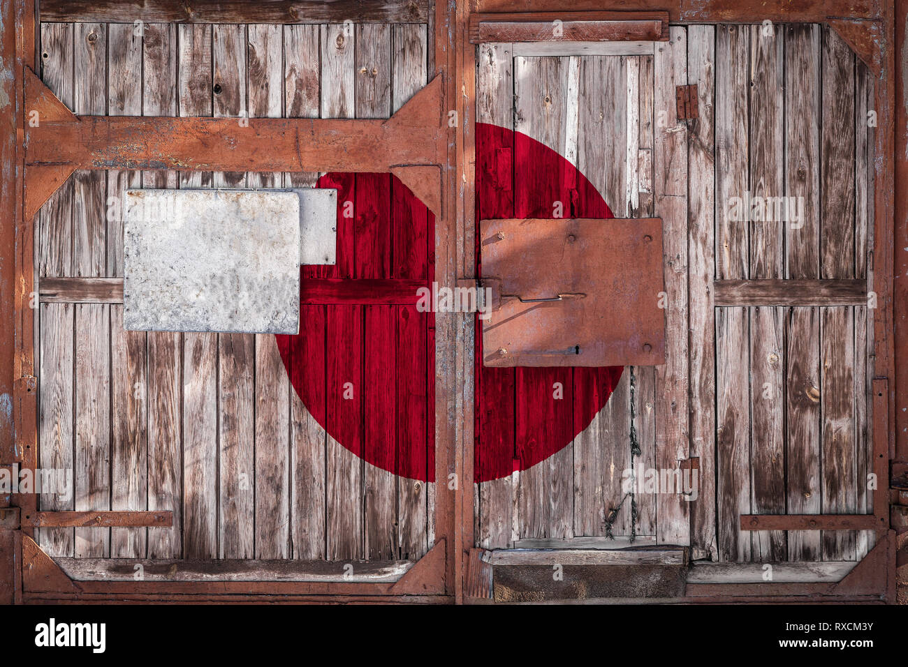 Close-up of old warehouse gate with national flag of Japan. The concept of export-import Japan, storage of goods and national delivery of goods. Flag  Stock Photo