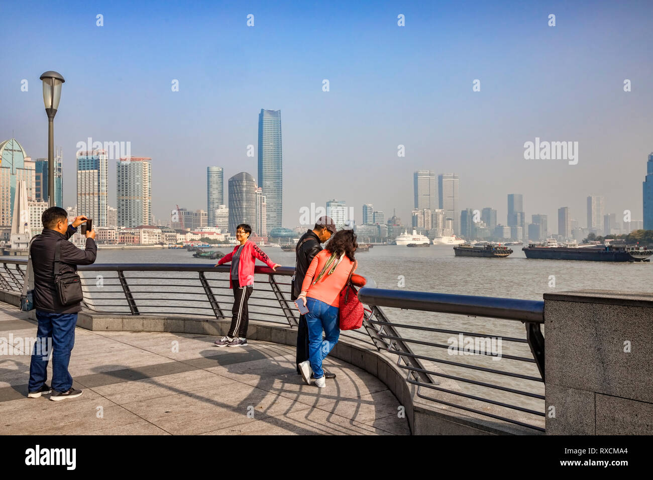 29 November 2018: Shanghai, China - Visitors on The Bund, beside the Huangpu River, Shanghai. Stock Photo