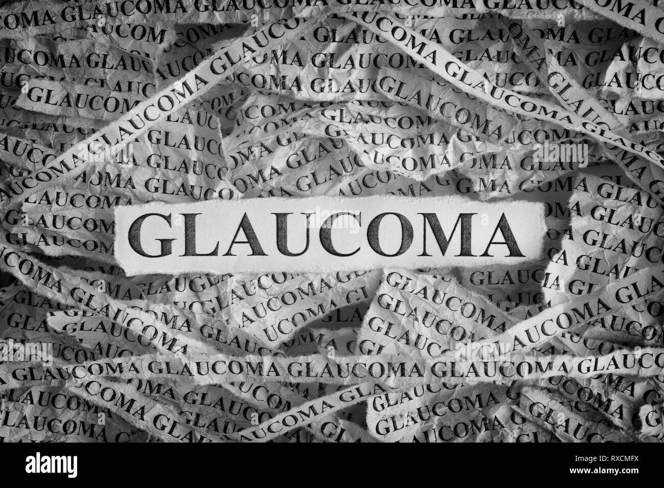 Glaucoma. Torn pieces of paper with the words Glaucoma. Concept image. Black and White. Close up. Stock Photo