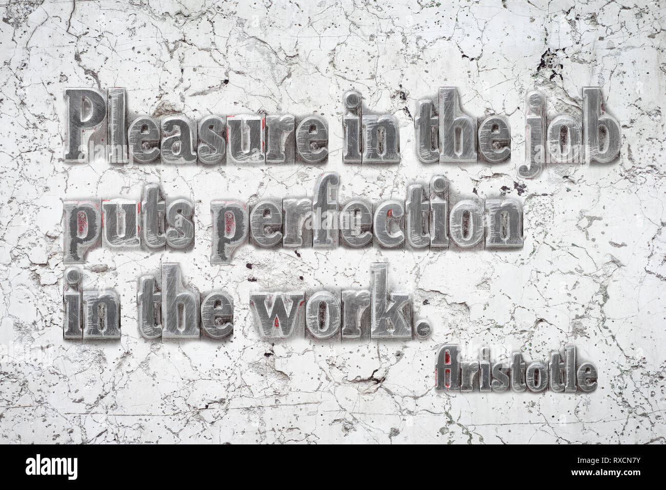 Pleasure in the job - ancient Greek philosopher Aristotle quote mounted on white marble wall Stock Photo