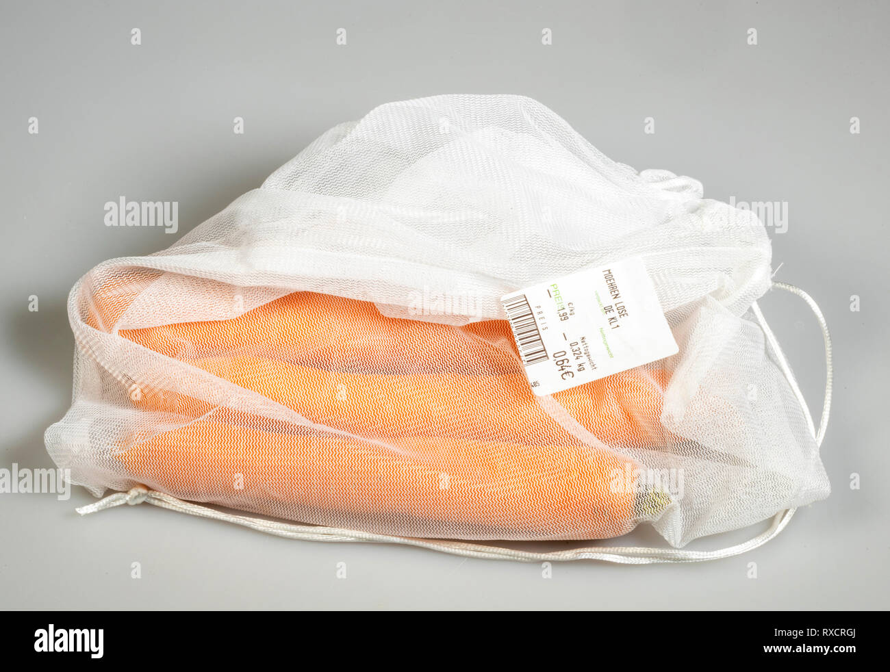 Food packaging, carrots in a reusable plastic net, avoidance of plastic waste, Stock Photo