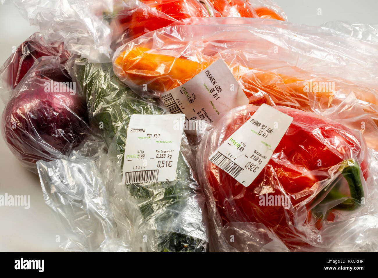 Food packaging, disposable plastic bags, vegetables, peppers, tomatoes, carrots, onions, from the supermarket, Stock Photo