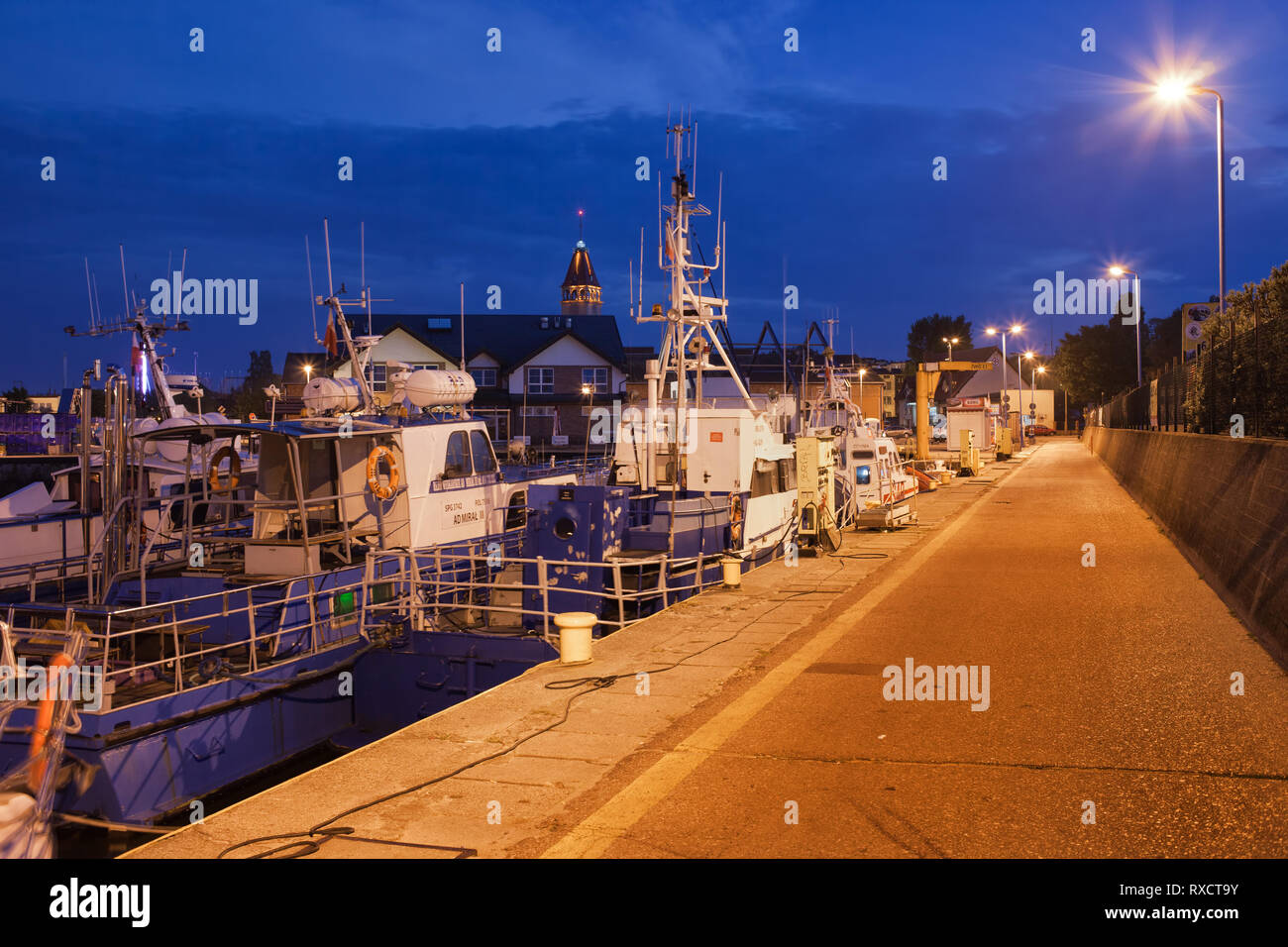 Poland, Pomerania, Kashubia, Wladyslawowo town, fishing boats in harbour at night Stock Photo