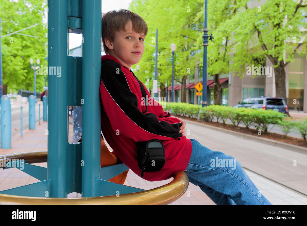 Young boy waiting for the Max Train in Portland, Oregon near Loyd Center. Stock Photo