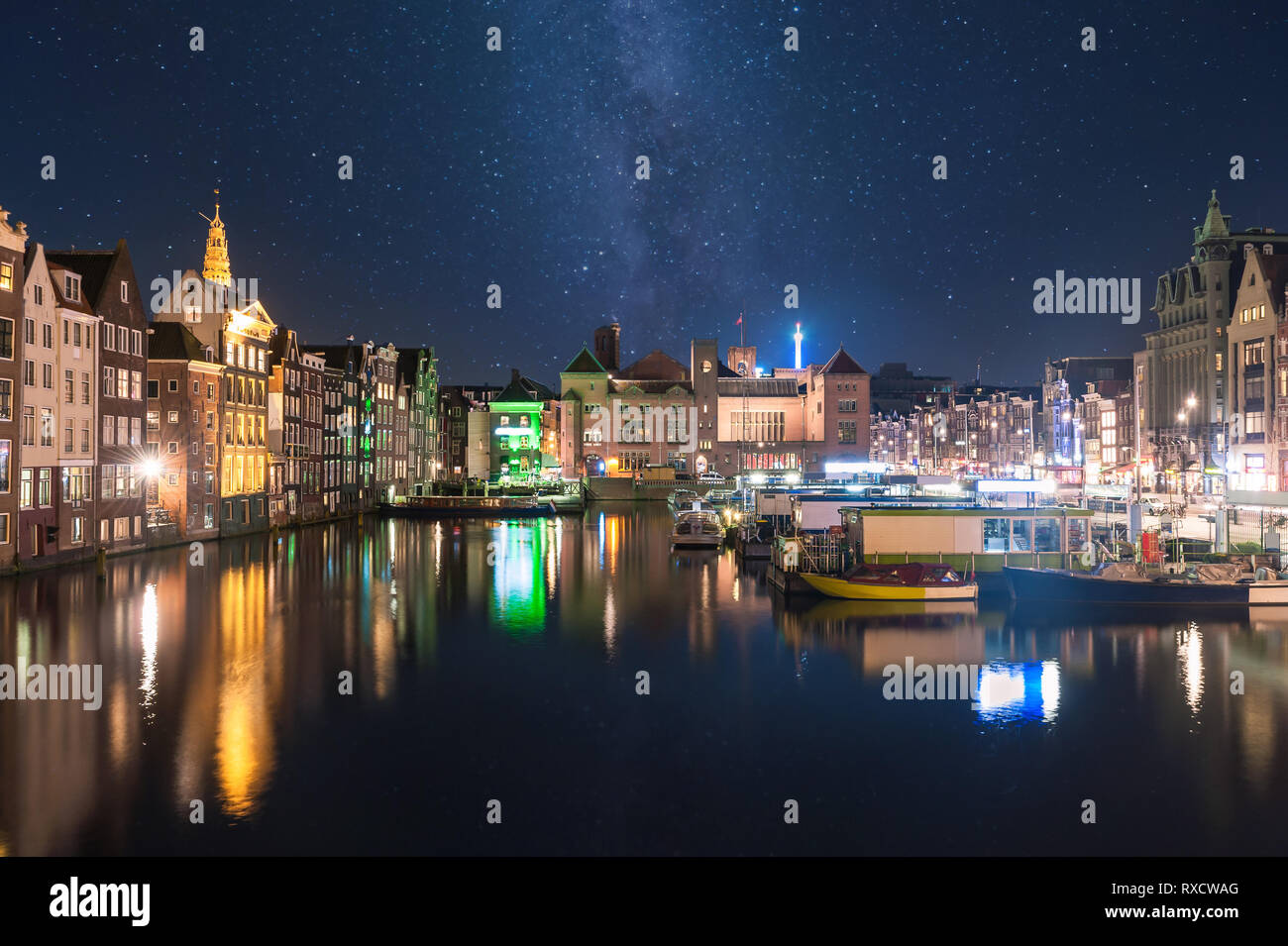 Night landscape with houses and canal in Amsterdam, light reflection in water, cityscape Stock Photo