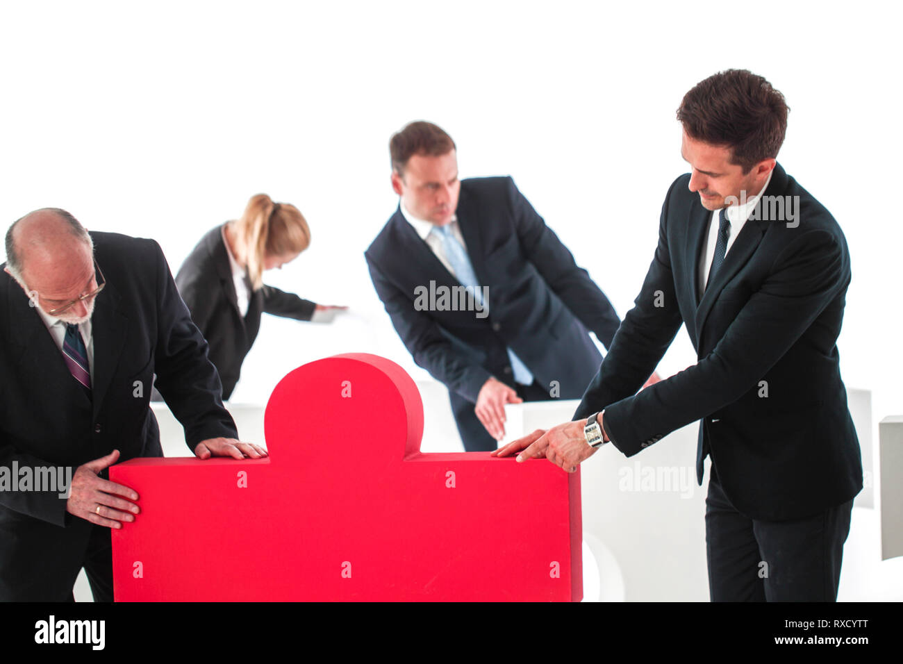 Business teamwork and problem solution concept . Business people with giant puzzle pieces . Partnership and collaboration , studio isolated on white b Stock Photo