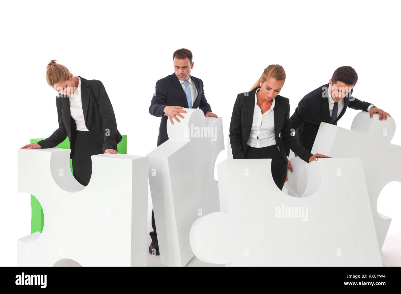 Business teamwork and problem solution concept . Business people with giant puzzle pieces . Partnership and collaboration , studio isolated on white b Stock Photo