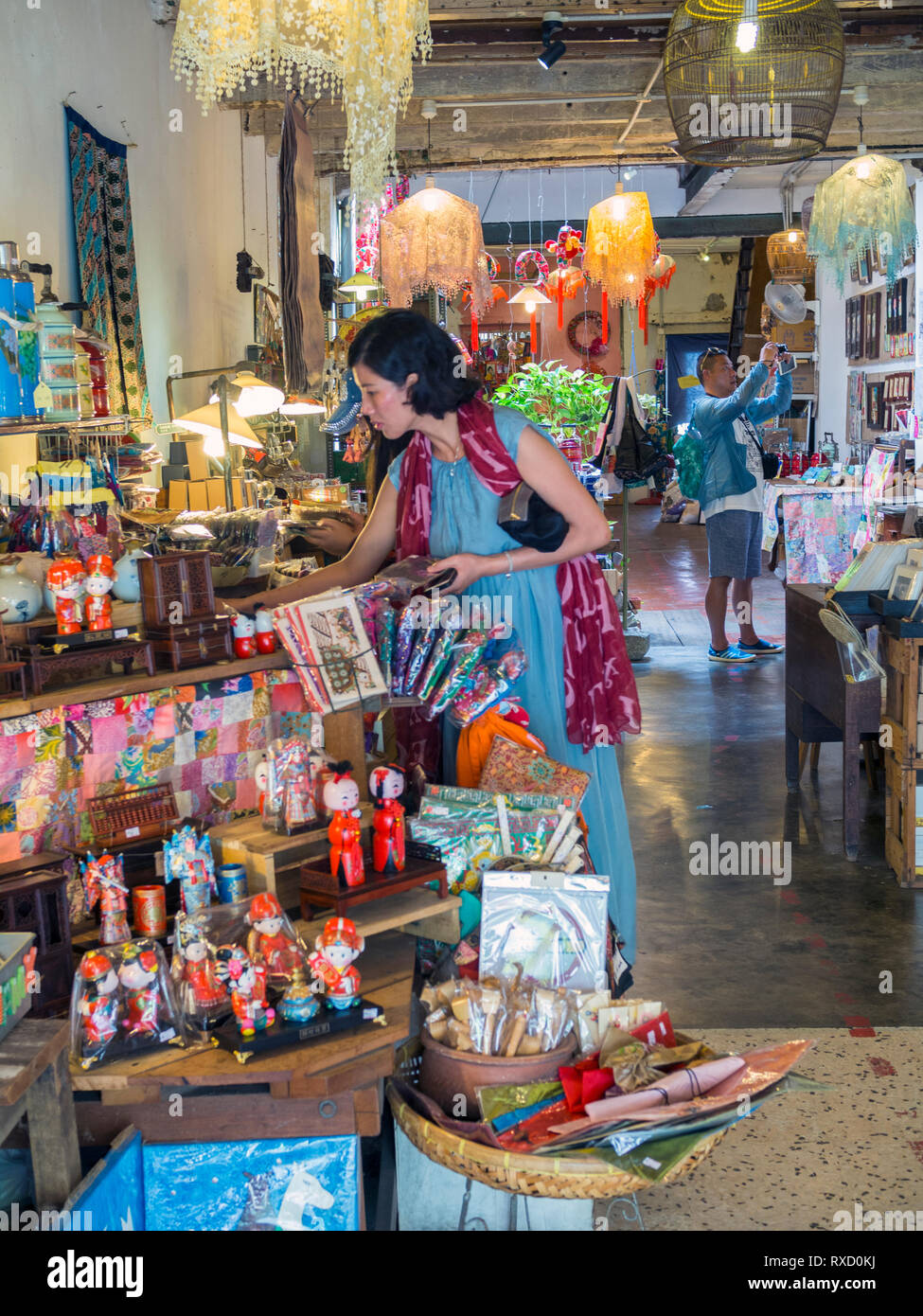 Tourists shopping for curios inside the shop 14 Living Story on Armenian Street, Penang. Stock Photo