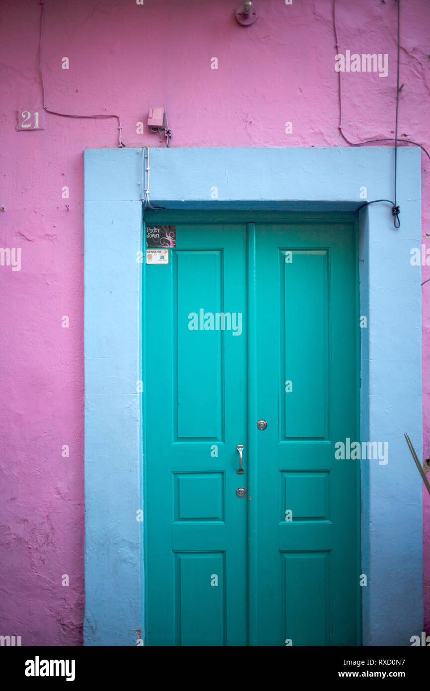 A door paint in blue in a pink wall in Guanajuato, Mexico. Stock Photo