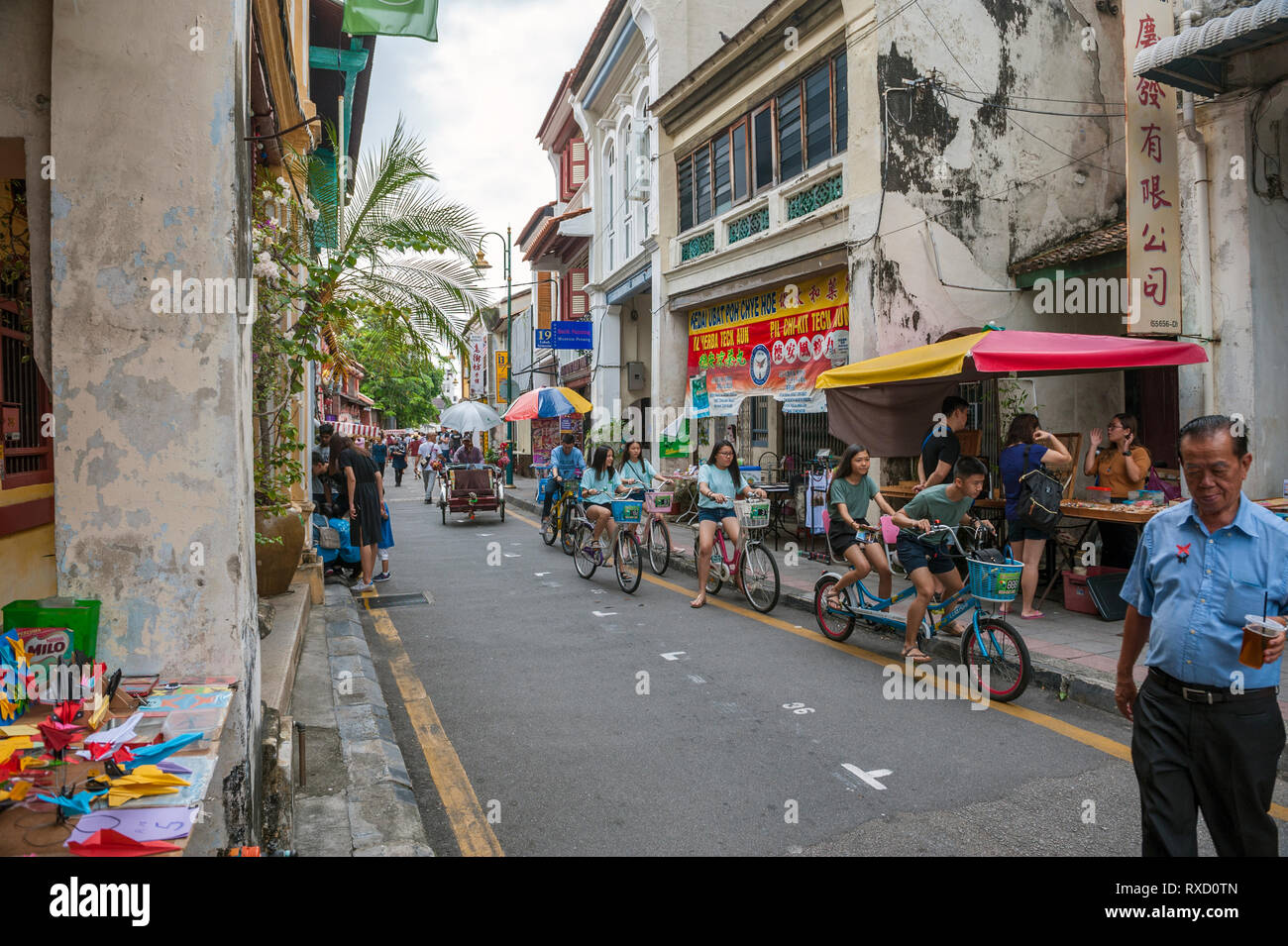 Tourists on Armenian Street in George Town, Penang. In the heart of the World Heritage district, the street is well known for its old clan temples and Stock Photo
