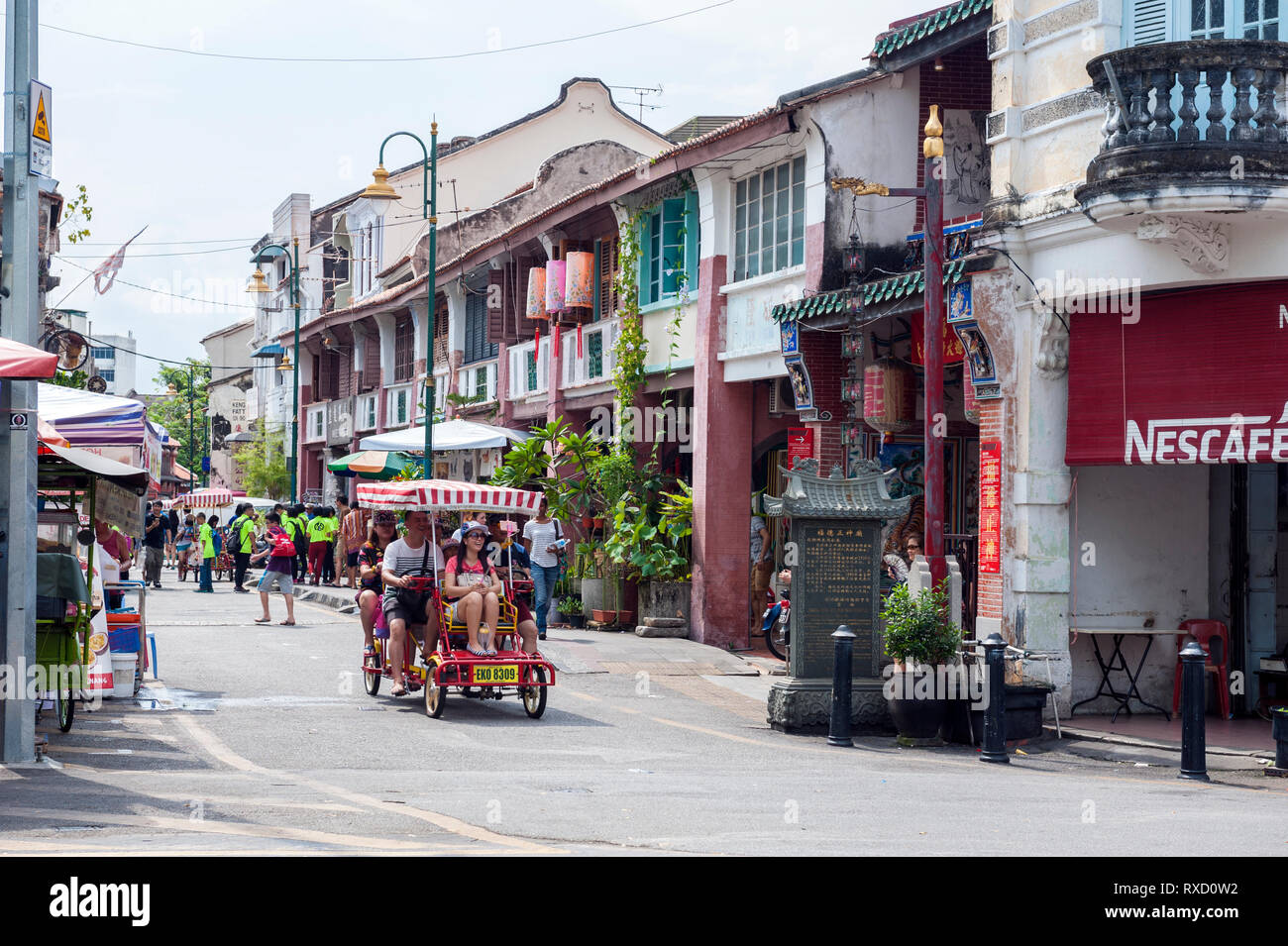 Tourists on Armenian Street in George Town, Penang. In the heart of the World Heritage district, the street is well known for its old clan temples and Stock Photo