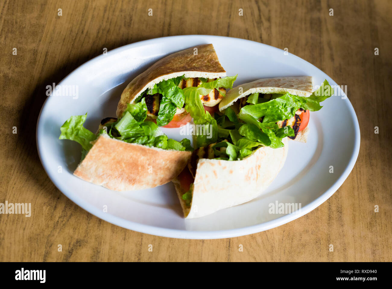 Grilled halloumi cheese with salad in pita in local restaurant in