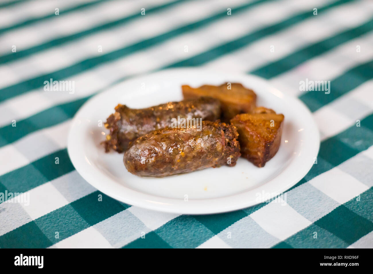 Pork wine sausage and belly in local restaurant in Larnaca. Traditional cypriot meze food on Cyprus island. Stock Photo