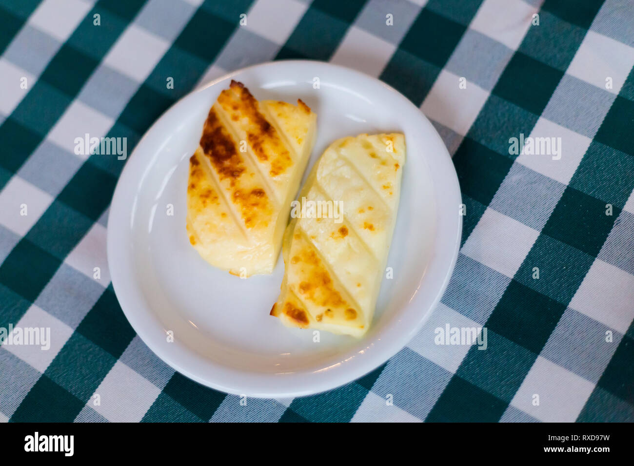 Grilled halloumi cheese in local restaurant in Larnaca. Traditional cypriot meze food on Cyprus island. Stock Photo