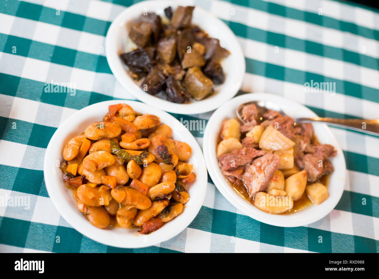Food selection of bean, pork, liver and potato in local restaurant in Larnaca. Traditional cypriot meze food on Cyprus island. Stock Photo