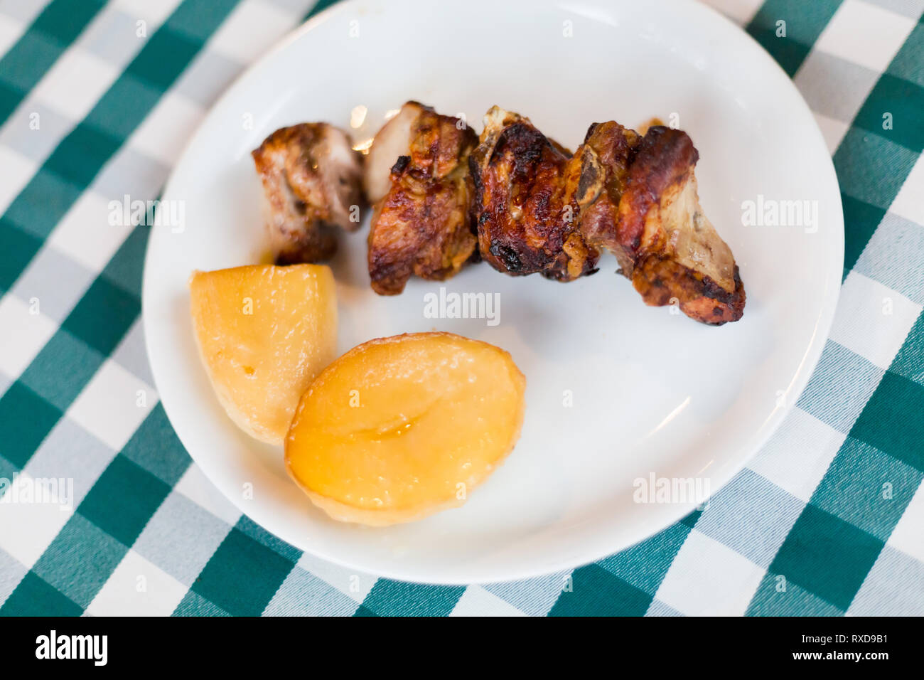 Pork ribs served with potato in local restaurant in Larnaca. Traditional cypriot meze food on Cyprus island. Stock Photo