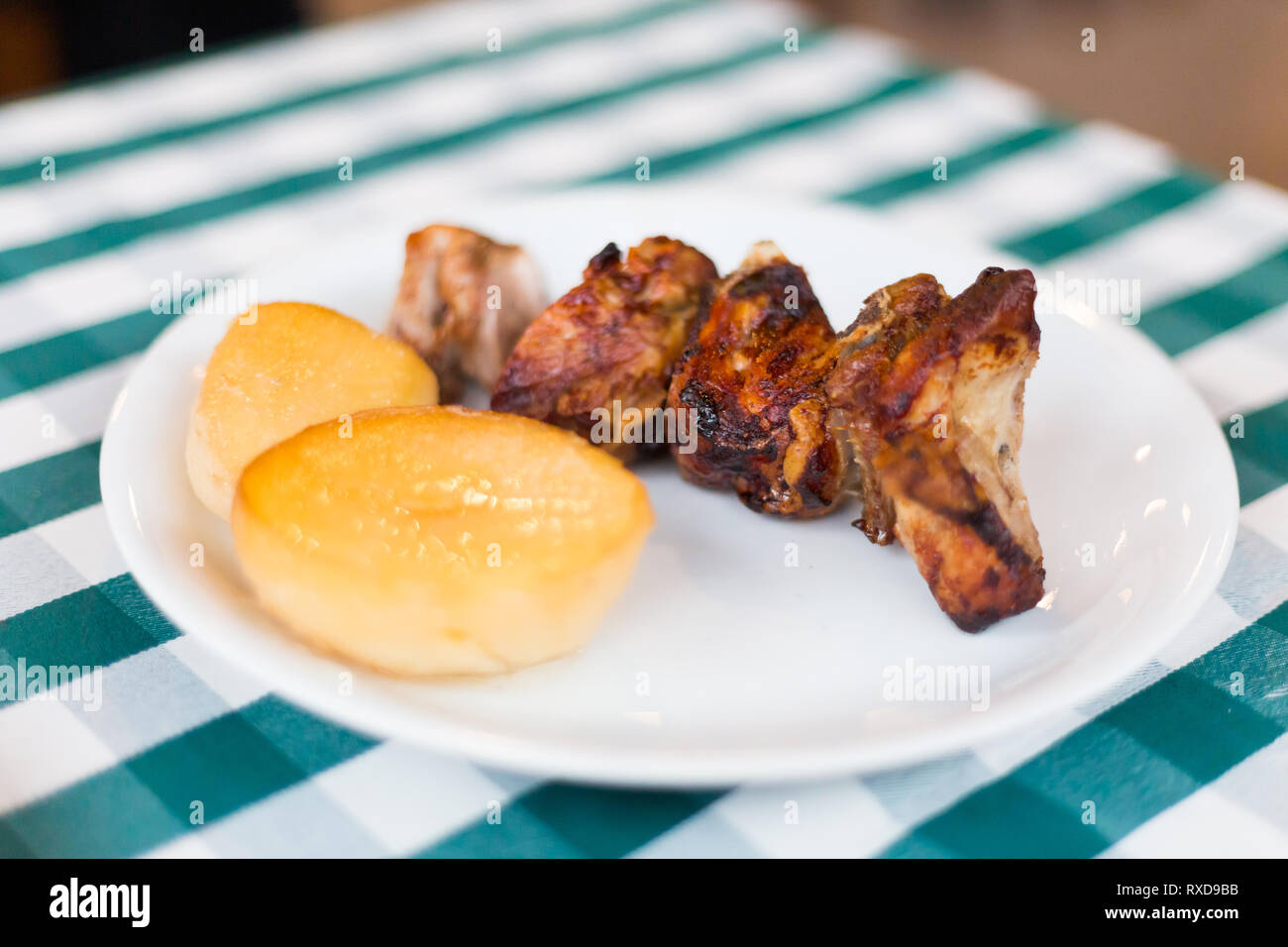 Pork ribs served with potato in local restaurant in Larnaca. Traditional cypriot meze food on Cyprus island. Stock Photo