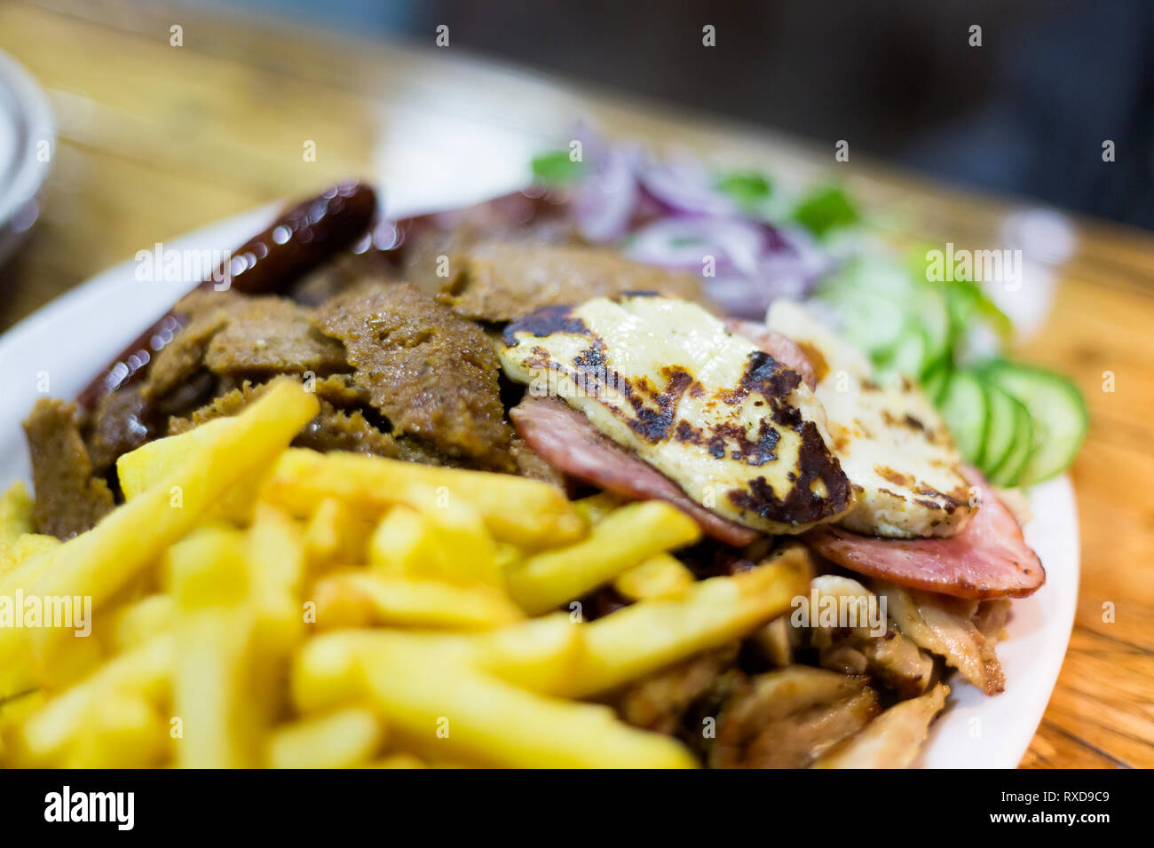 Mix kebab grill and halloumi with fries in local restaurant in Paphos