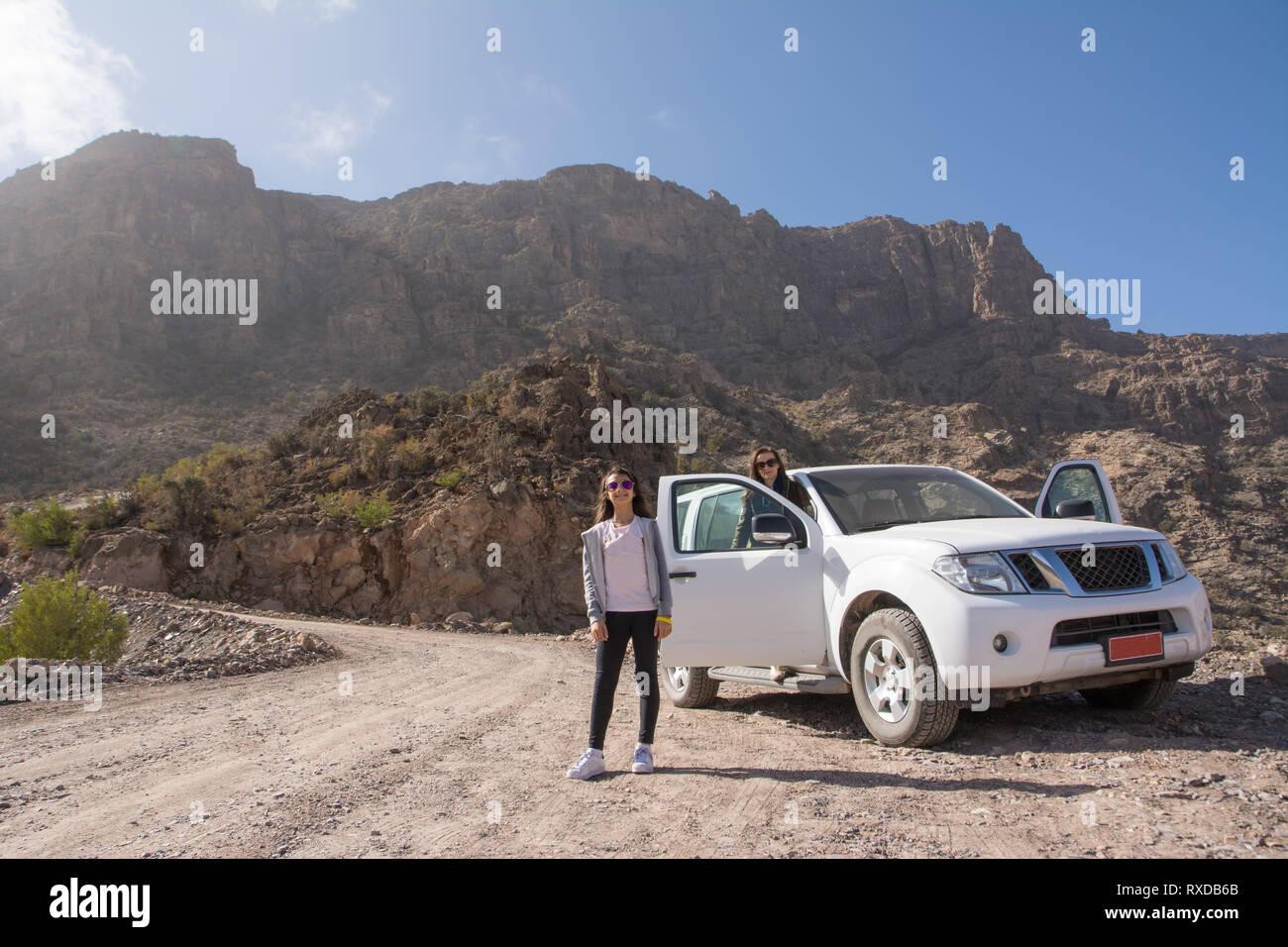 Off-road vehicle and tourists on the Jebel Shams mountains (Oman) Stock Photo
