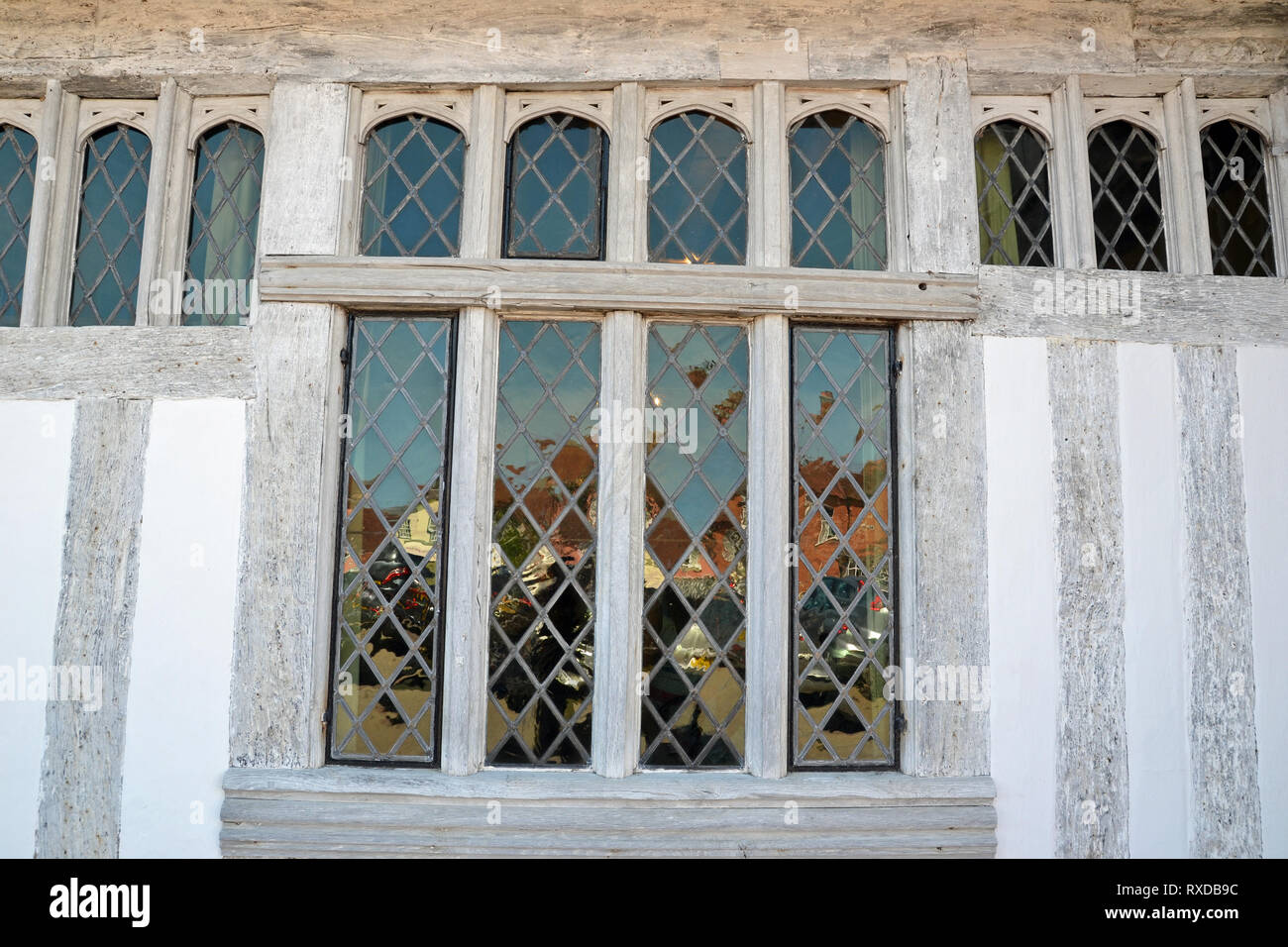 The leaded windows and timber beams of Lavenham Guildhall in Lavenham,  Suffolk, UK. Sunny day Stock Photo - Alamy