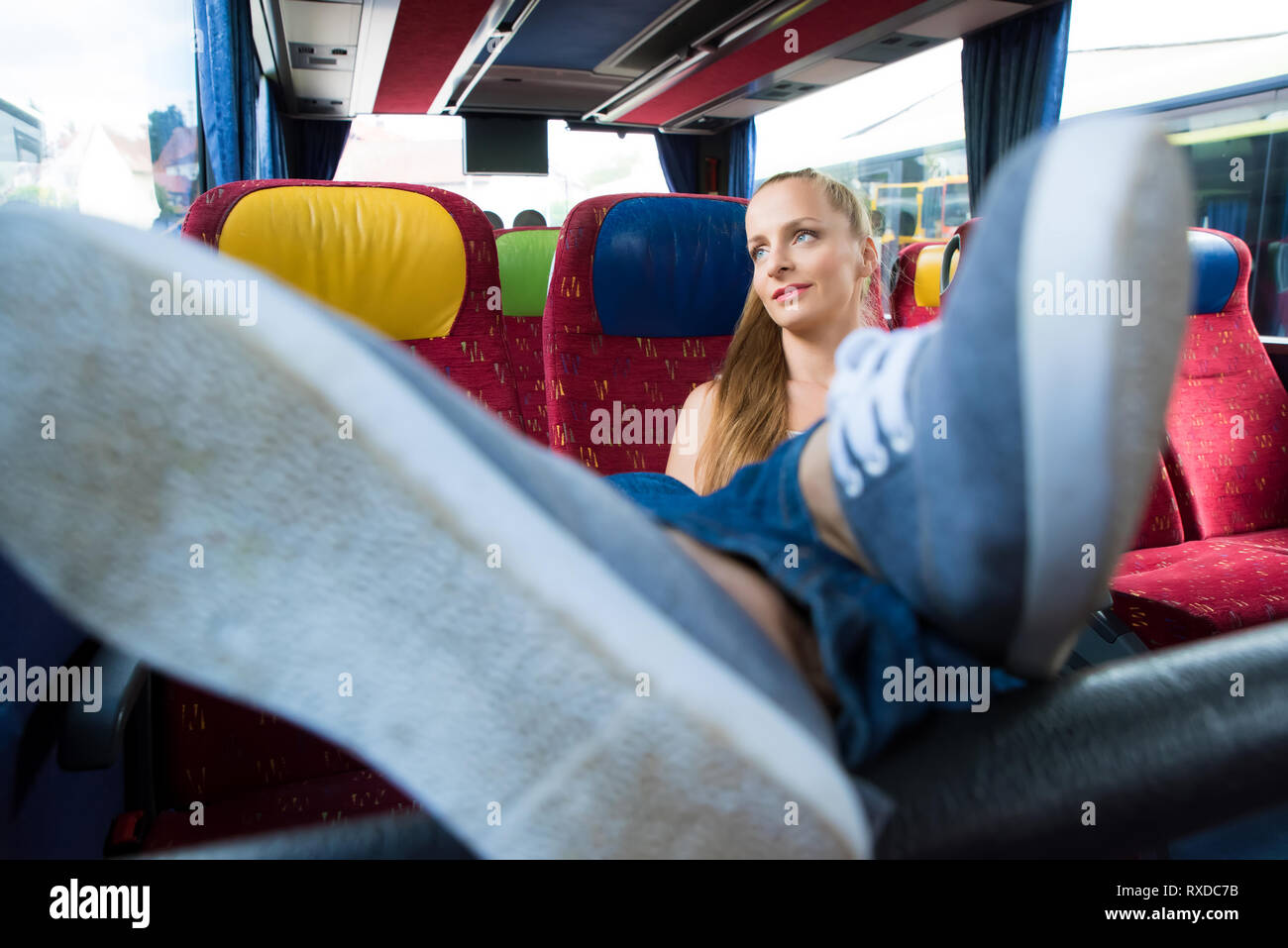 A young woman sitting comfortably on the bus Stock Photo Alamy