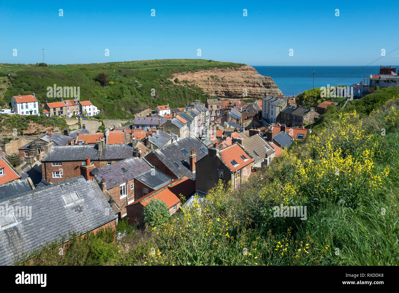 The picturesque coastal village of Staithes, North Yorkshire, England. Looking down on cottages by Staithes Beck and Cowbar Nab. Stock Photo