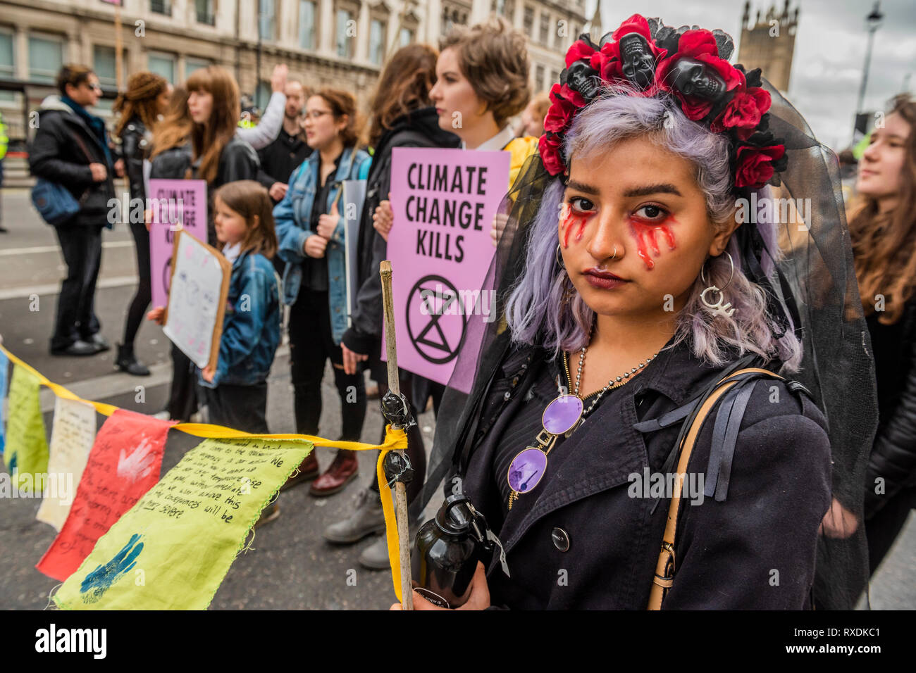 London, UK. 09th March, 2019. The theme was to wear funereal black - The Blood of our Children protest organised by Extinction Rebellion - An Act of Civil Disobedience to call for action against climate change. Activists pour (artificial) blood on the ground outside Downing Street. They were protesting on behalf of the next generation who will face a future defined by the climate and ecological breakdown. The believe they must 'rebel for life'. Credit: Guy Bell/Alamy Live News Stock Photo