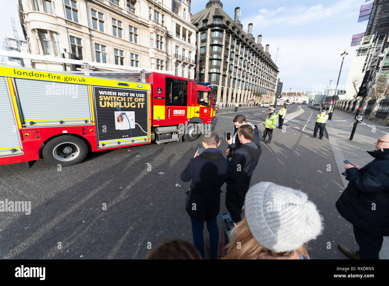 A suspicious car parked outside New Scotland Yard police headquarters on Victoria Embankment, Westminster, London, UK caused the police to lockdown and clear the the area around it and Westminster Bridge, including stopping river traffic on the Thames. Police broke the rear screen of the car to gain entry. Stock Photo