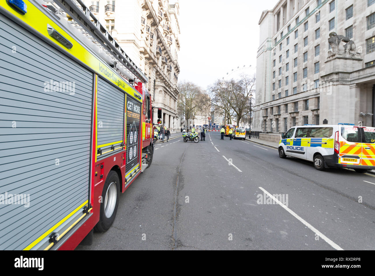 A suspicious car parked outside New Scotland Yard police headquarters on Victoria Embankment, Westminster, London, UK caused the police to lockdown and clear the the area around it and Westminster Bridge, including stopping river traffic on the Thames. Police broke the rear screen of the car to gain entry. Stock Photo