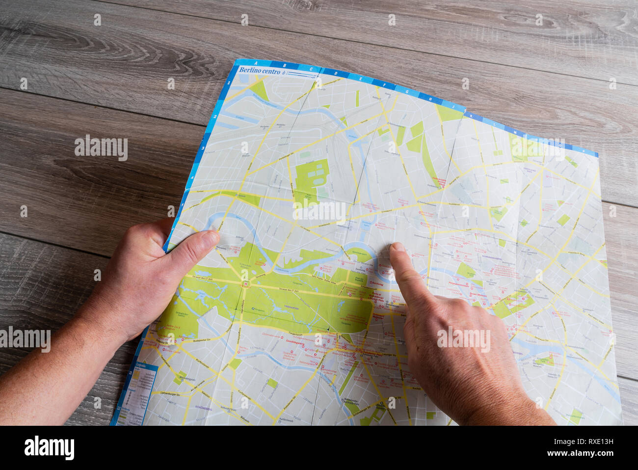 the consultation of the city map of Berlin Stock Photo