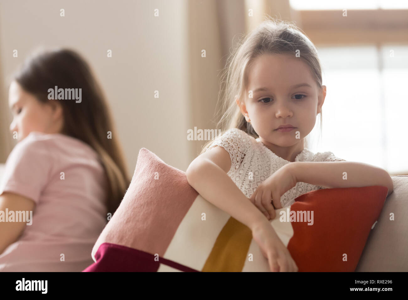 Upset kid daughter feeling sad after fight with mother Stock Photo