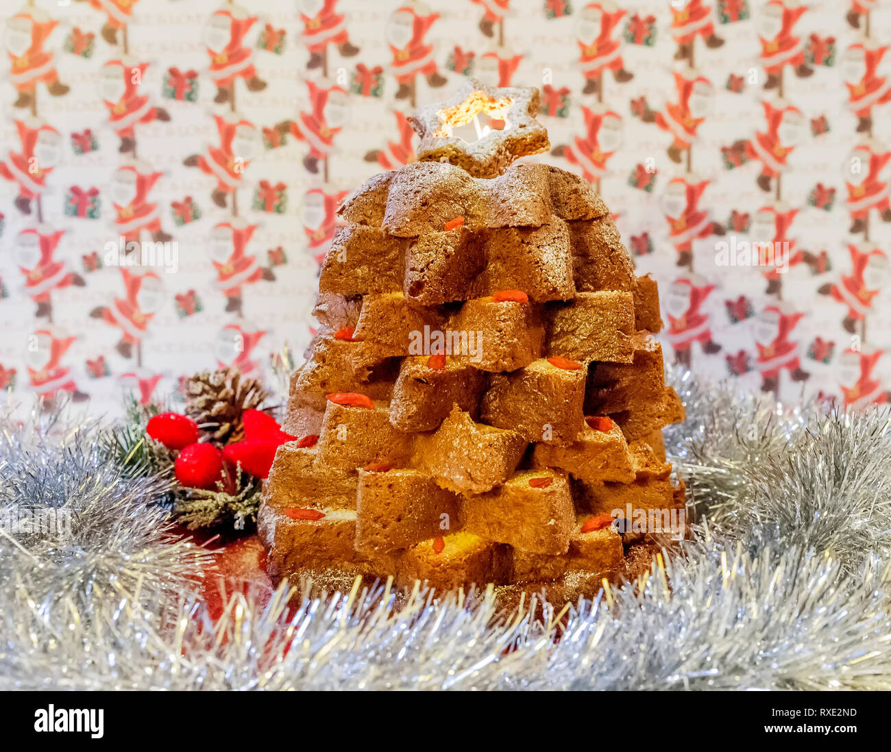 Christmas composition with Pandoro, a typical Italian dessert, cut in a star shape and decorations with Goji berries Stock Photo
