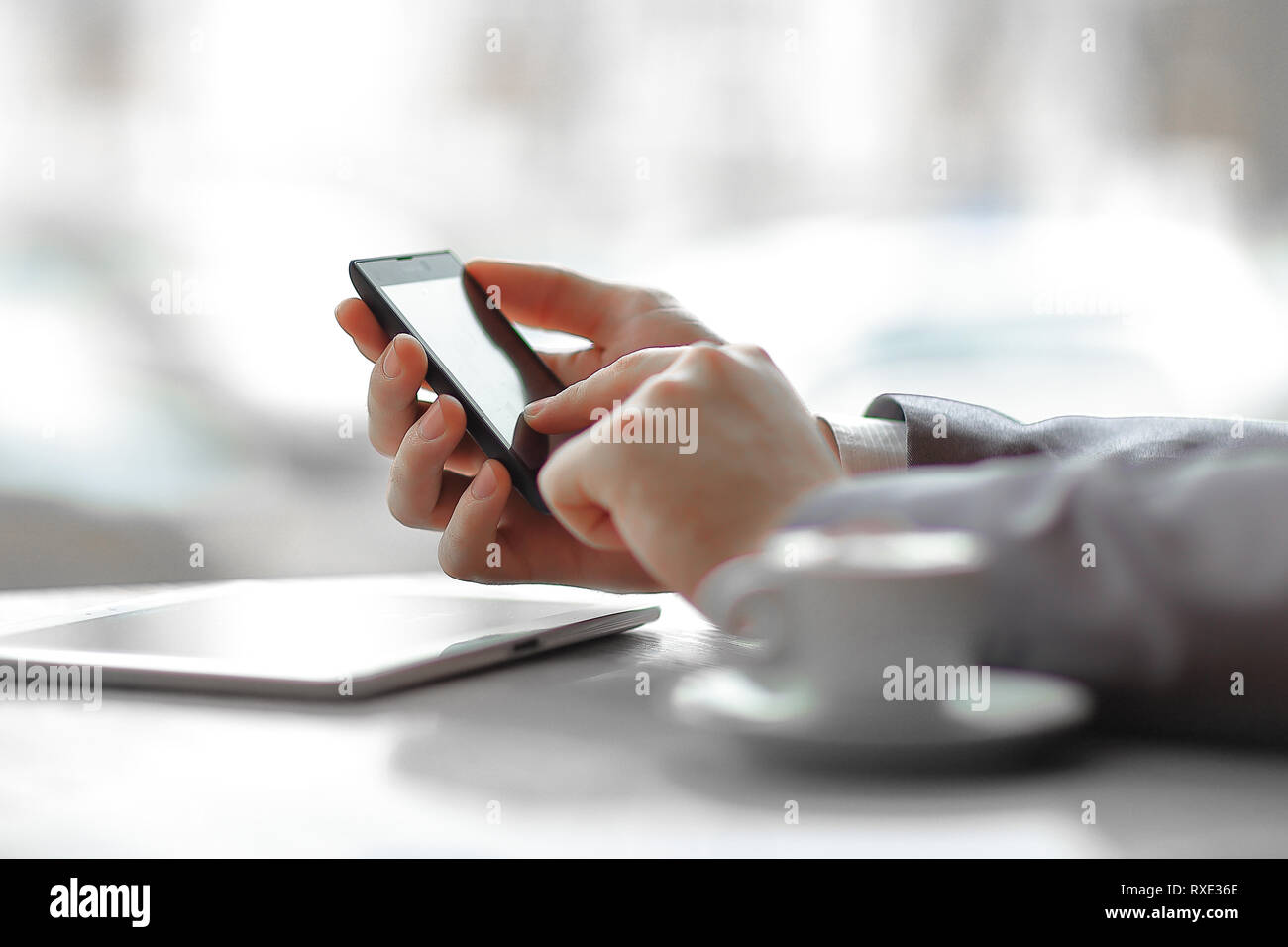 close up.businessman presses his finger on the screen of the smartphone Stock Photo