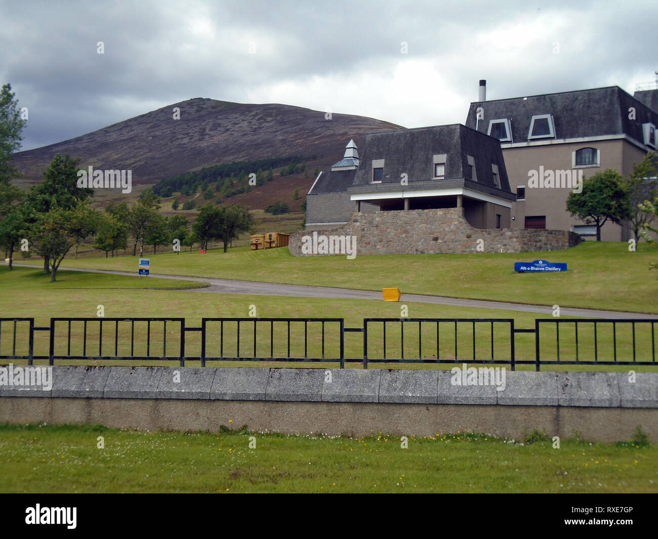 The Allt-a-Bhainne Whiskey Distillery and the Scottish Mountain Corbett Ben Rinnes in the Cairngorm National Park, Scotland, UK. Stock Photo