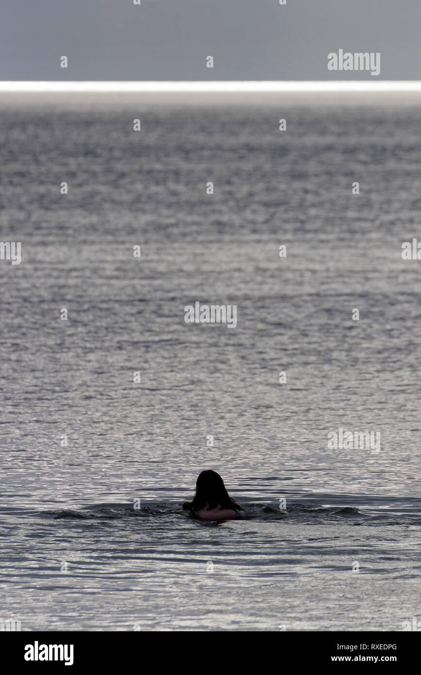 Swimming out to sea, alone Stock Photo
