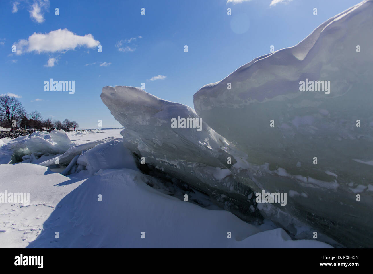 Ice build up along the shore of Lake Ontario causes ice sheets to reach out towards the sky. Stock Photo