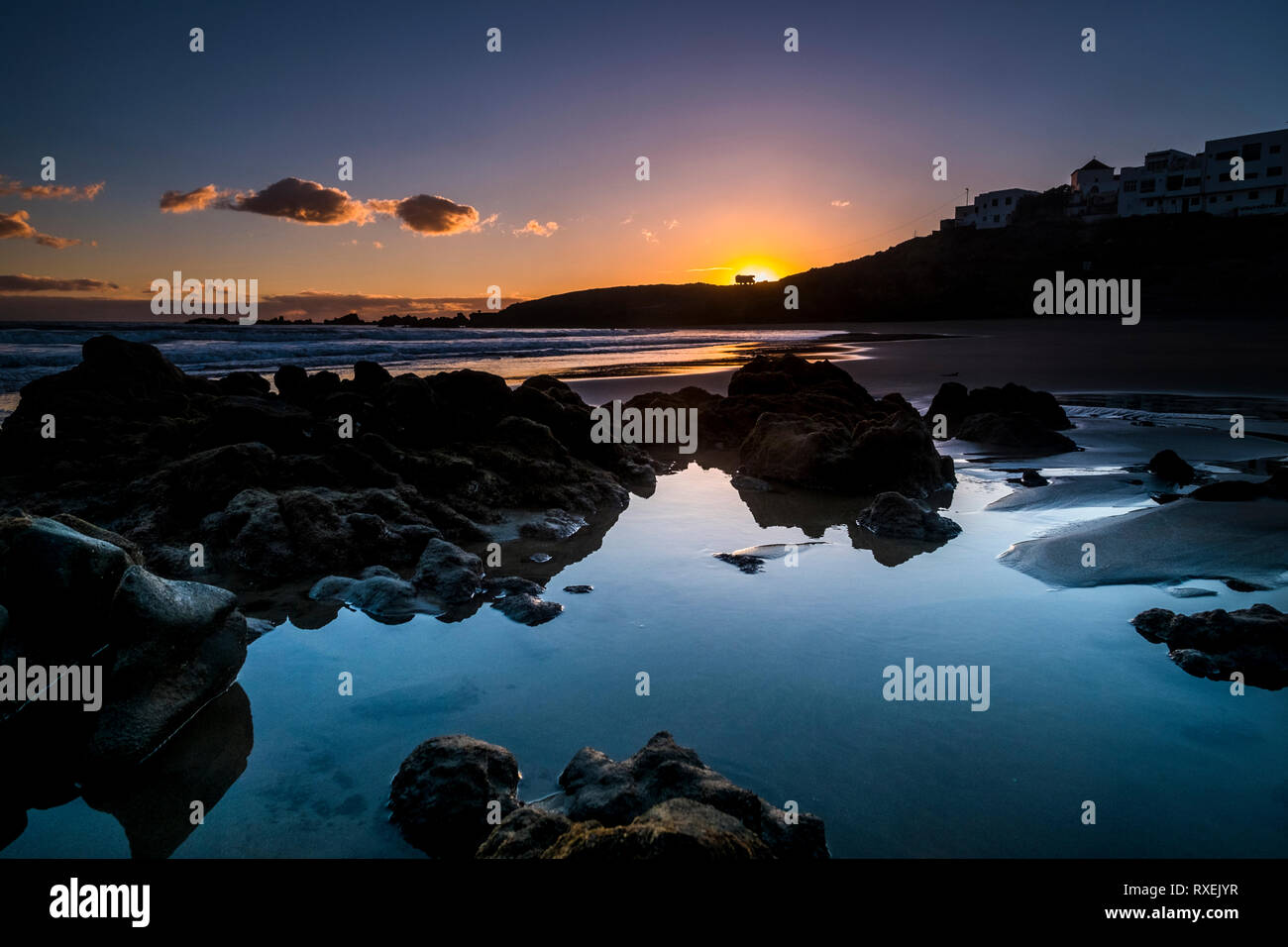 Sunrise or sunset at the ocean beach - beautiful colors and wave and sky - environment and vacation scenery place concept - landscape with coastal cit Stock Photo