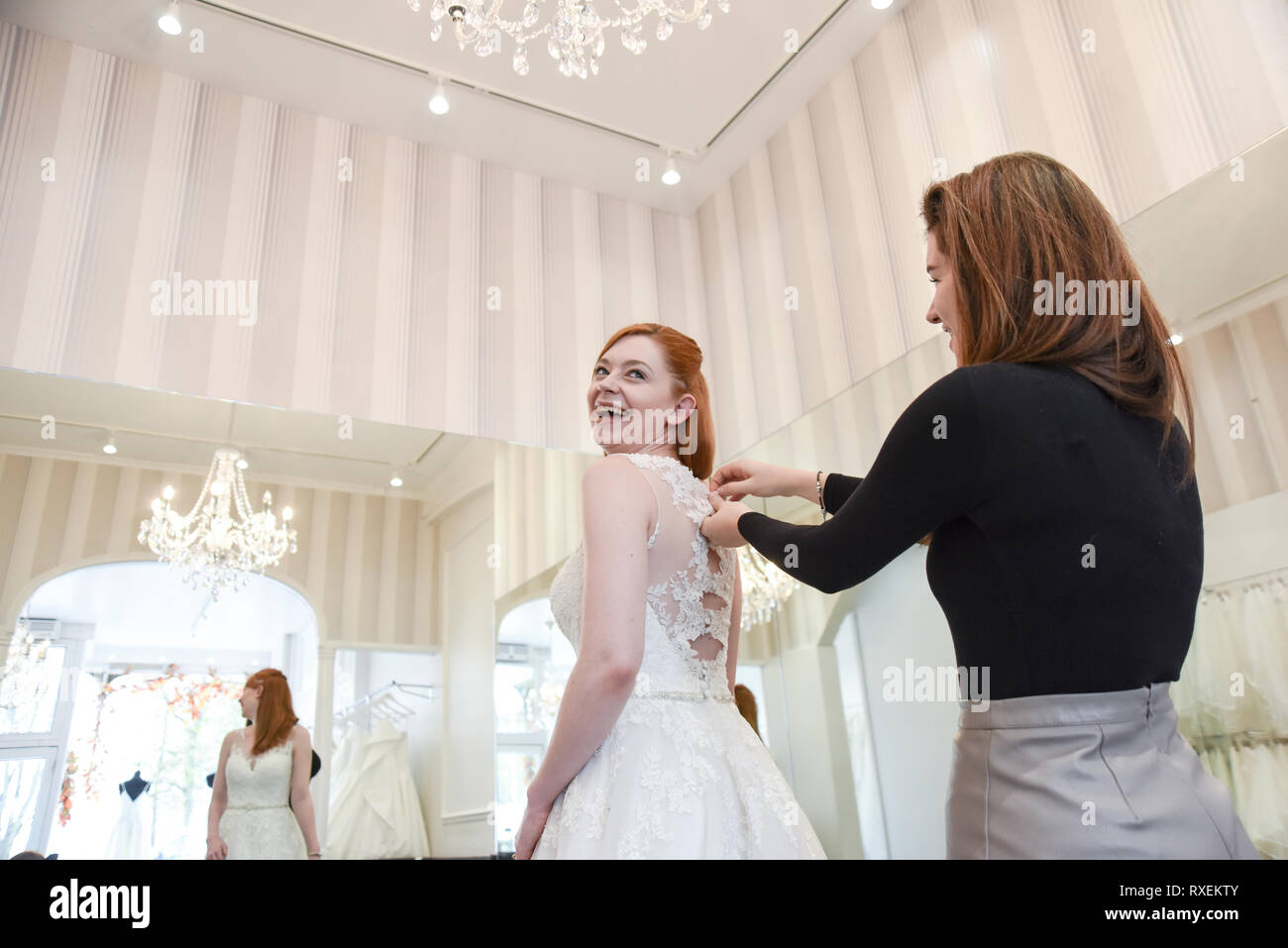 Pretty caucasian girl trying on Wedding dresses in an upmarket Bridal