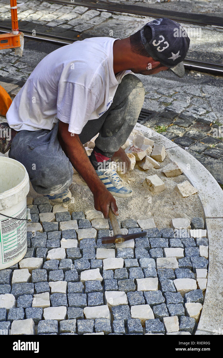 Craftsman puts paving stones in Lisbon, 2019 Stock Photo