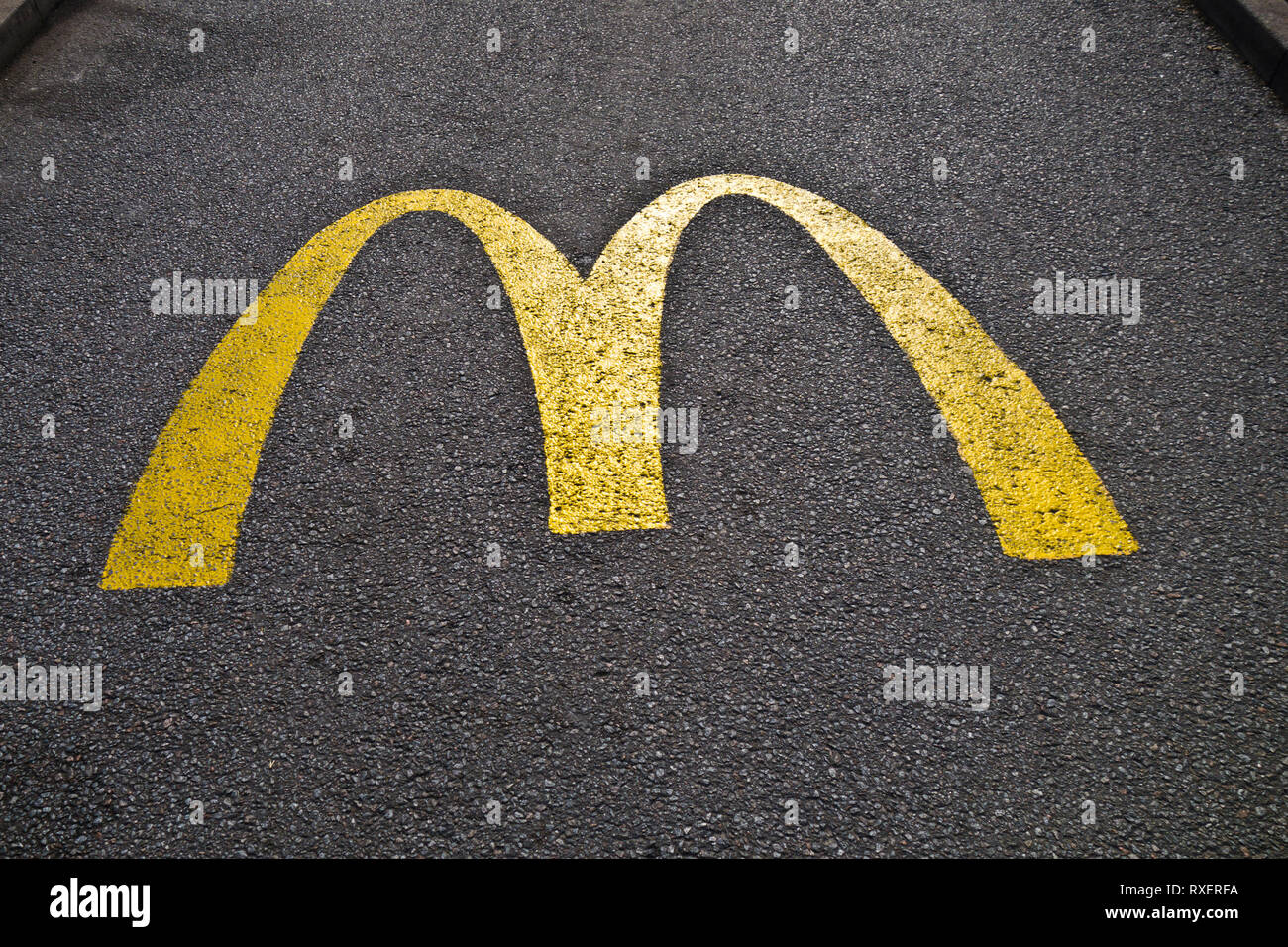 McDonald's yellow logo painted on the asphalt Stock Photo Alamy